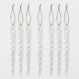 Seven clear spiral icicle ornaments with silver hanging loops are arranged vertically against a plain white background.