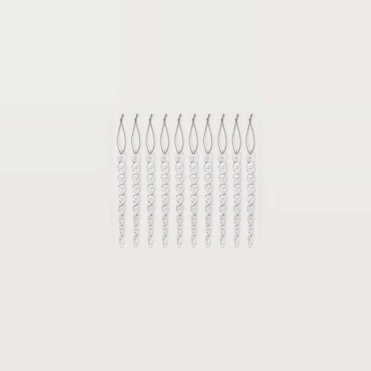 Ten clear twisted icicle ornaments with silver hanging loops form a compact row centered against a white background.