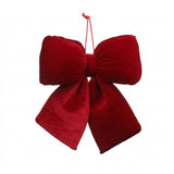 A red velvet Christmas bow with gathered loops, two wide tails, and a red hanging cord appears against a white background.