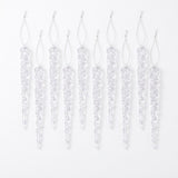 Ten clear icicle ornaments with silver hanging loops are arranged in alternating heights on a white background.