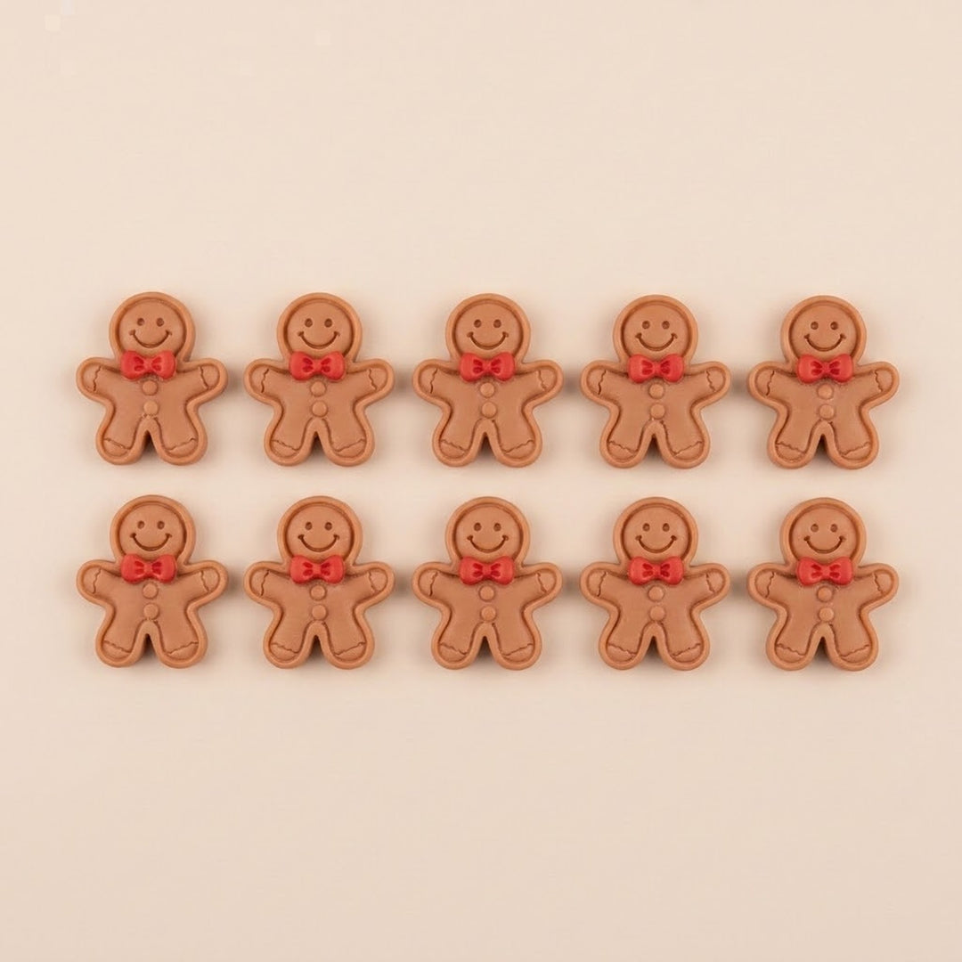 Ten brown resin gingerbread craft embellishments with outlined edges, red bows, and brown buttons sit in two rows against beige.