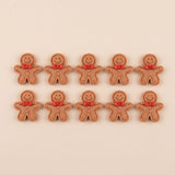 Ten brown resin gingerbread craft embellishments with outlined edges, red bows, and brown buttons sit in two rows against beige.