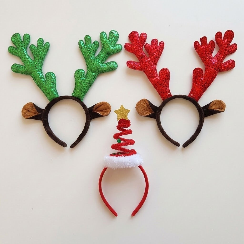 Three headbands feature green sequin antlers, red sequin antlers, and a red spiral Christmas tree with a gold star against a pale background.