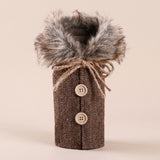Brown herringbone wine bottle cover has a fluffy gray collar, twine bow and two beige buttons against a pale beige background.