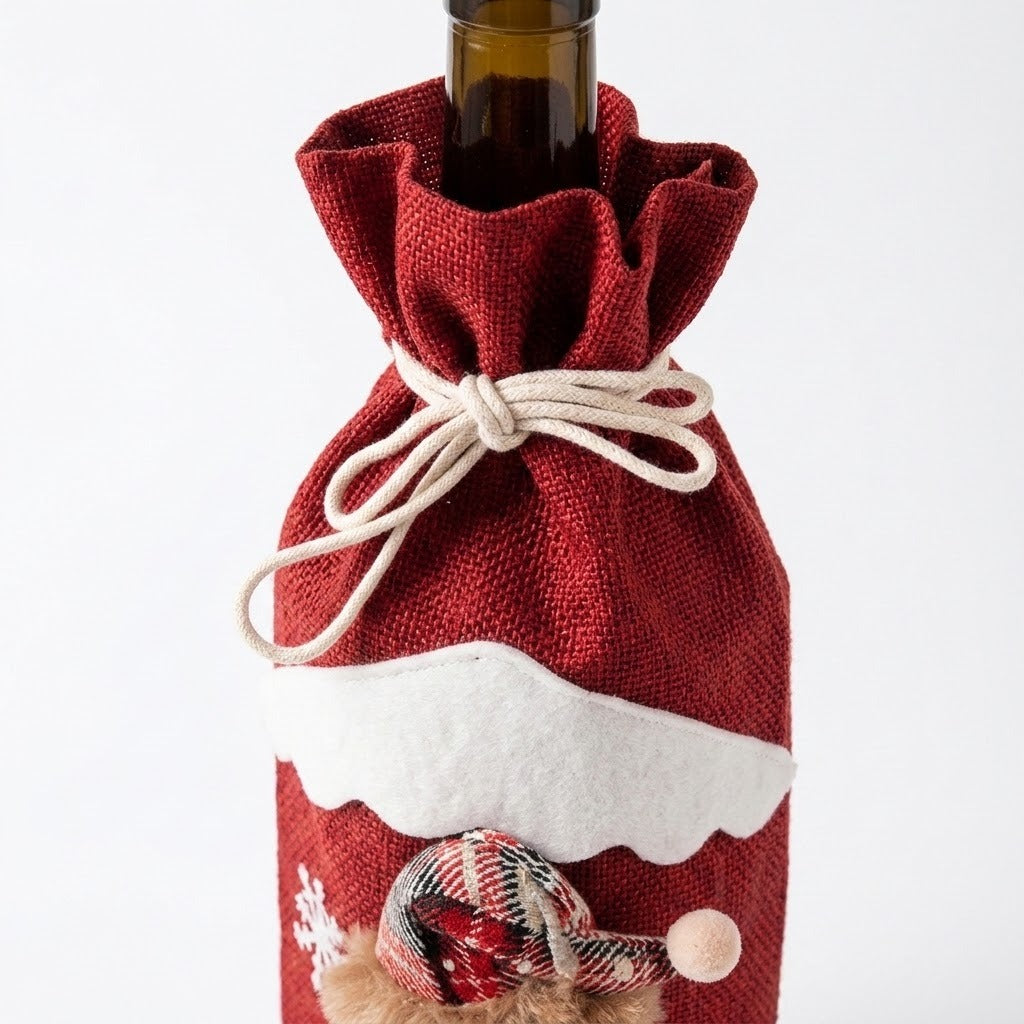 Cream drawstrings form a bow around a red woven wine bottle cover, with white scalloped trim visible against a white background.