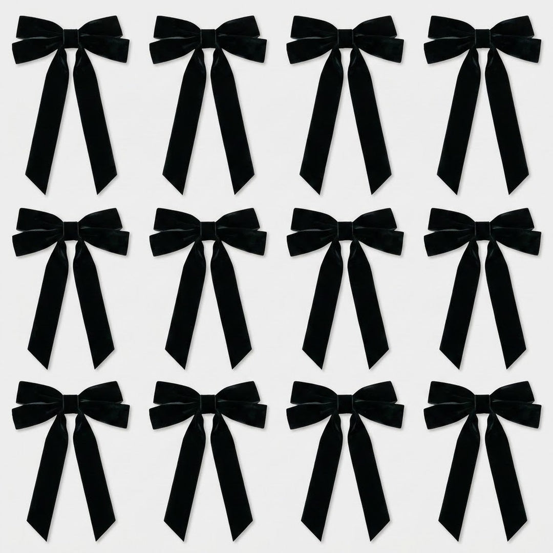 Twelve black velvet Christmas bows with long angled tails are arranged in three rows of four on a light gray background.