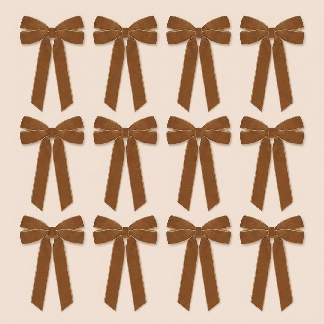 Twelve brown velvet Christmas bows with long angled tails are arranged in three rows of four on a pale beige background.
