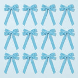 Twelve light blue velvet Christmas bows with long angled tails are arranged in three rows of four on a pale blue background.