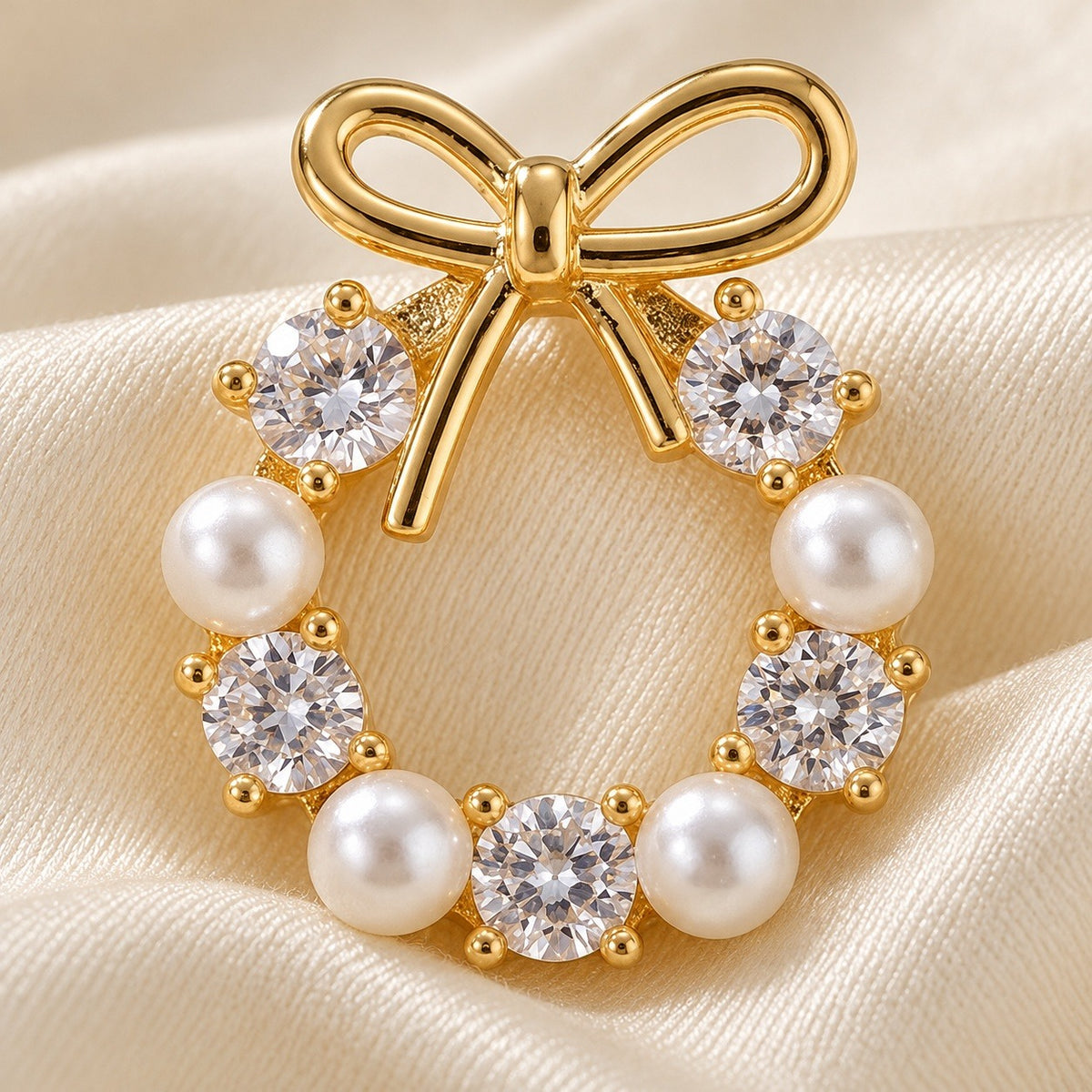 A close-up shows a gold-tone bow stud earring with alternating white pearl-like beads and clear faceted stones on cream satin.