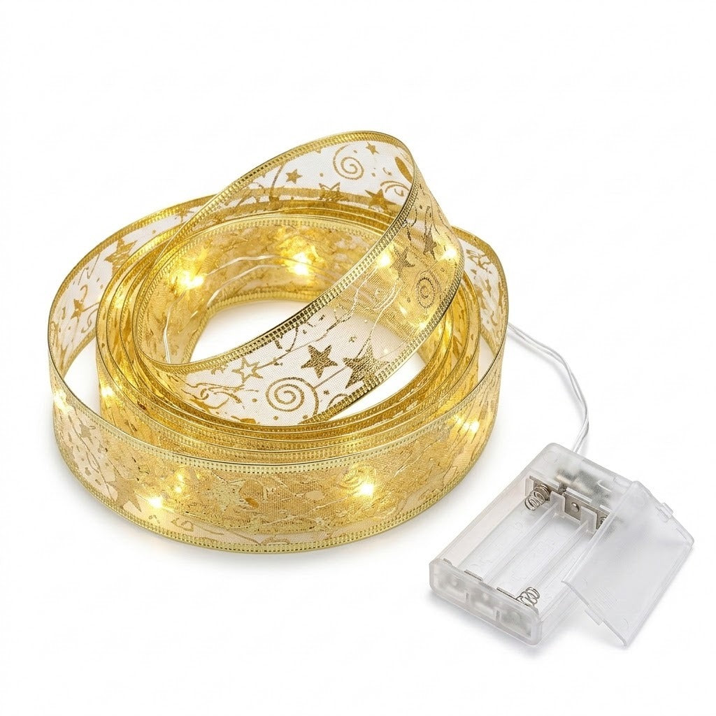 A translucent gold ribbon light string with star patterns glows in coils beside an open, empty clear battery box on a white background.
