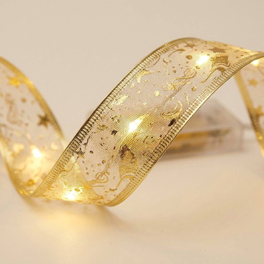 A gold mesh ribbon light string curves against a cream background, showing metallic edging, stars, musical notes, and warm glowing lights.