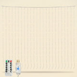 Warm white LED curtain string light strands with a small remote control and USB power plug on a plain beige background.
