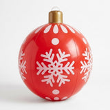 A red inflatable Christmas ornament with white snowflakes, dots, a gold cap, and a clear hanging loop stands against a white background.