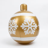A gold inflatable Christmas ornament with white snowflakes, two white stripes, and visible panel seams stands against a white background.