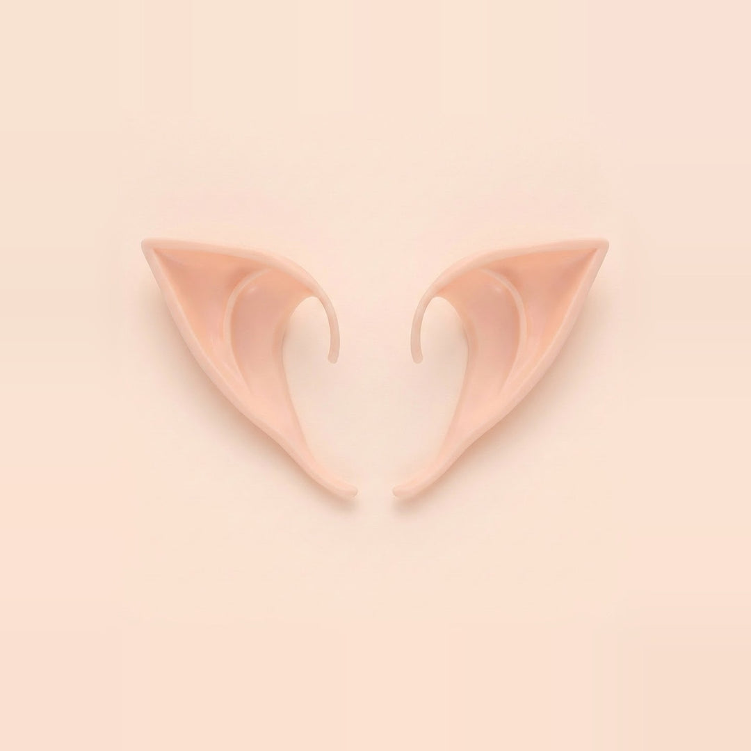 Light peach latex elf costume ears with curved hooks lying side by side on a pale peach background, 3.94 in (10 cm) pair.