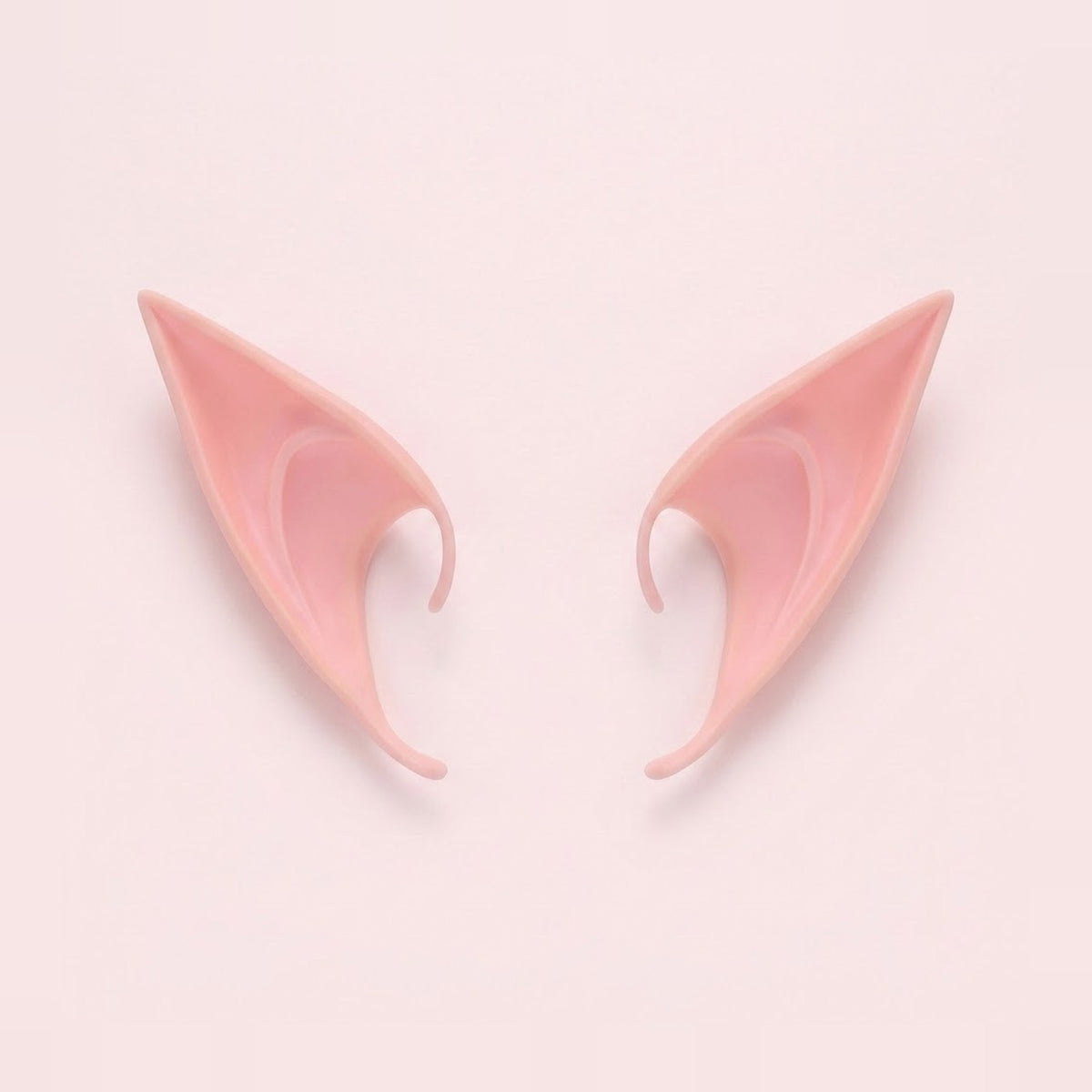 Pink latex elf costume ears with curved hooks lying side by side on a pale pink background, 4.72 in (12 cm) pair.