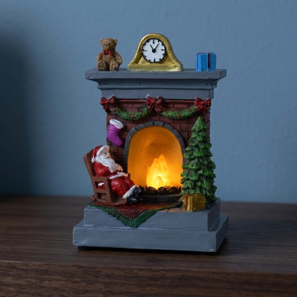 A Santa fireplace Christmas decorative light with a gray base and glowing orange hearth stands on dark wood against a blue wall.