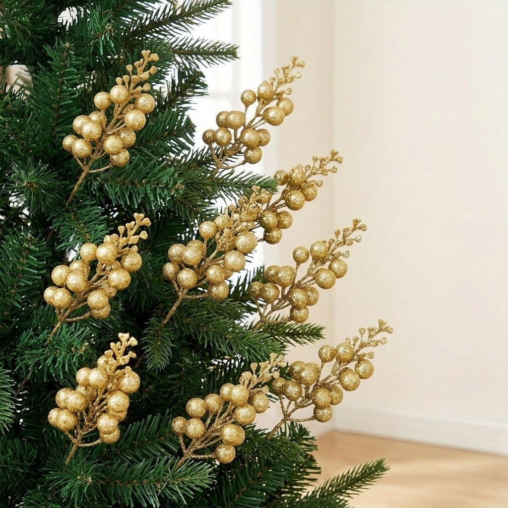 Gold glitter berry picks decorate green Christmas tree branches beside a cream wall and light wooden floor.