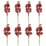 Eight red glitter berry picks with green stems are arranged in two rows of four against a white background.