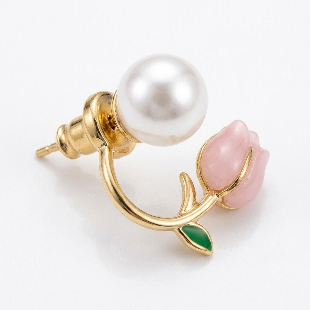 A pink tulip stud earring with curved gold-tone metalwork, green leaf, and white pearl-like accent shows its post and push-back on white.