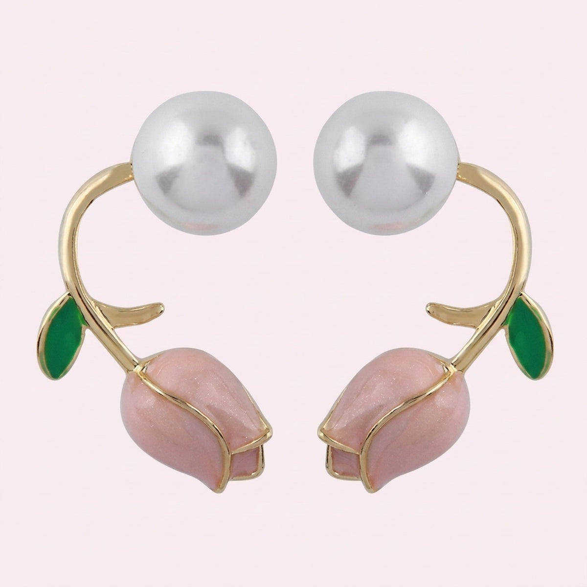 Pale pink tulip bud stud earrings with curved gold-tone stems, green leaves, and large white pearl-like beads on a pale background.