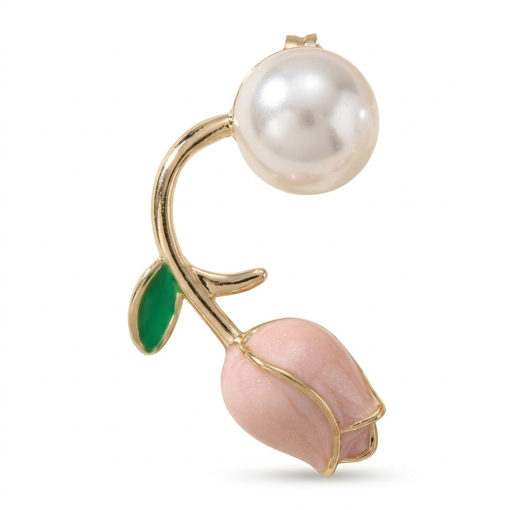 A gold-tone tulip stud earring stands upright against white, with a white pearl-like bead above its green leaf and pink bud.
