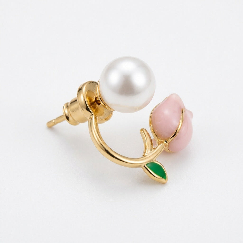 An angled tulip stud earring displays its gold-tone post and push-back, white pearl-like accent, pink bud, and green leaf on white.