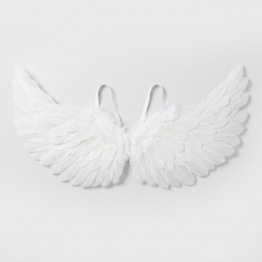 White feather costume wings have layered feathers, raised tips, and two visible shoulder loops against a pale gray background.