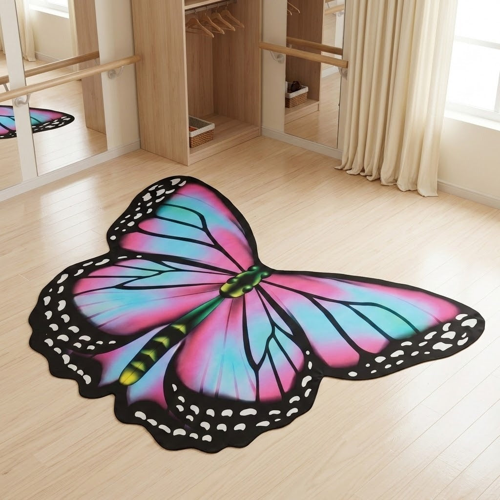 Pink and blue chiffon butterfly wing cape spread flat on a light wood floor in a bedroom with wardrobe and curtains.