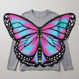 Pink and blue butterfly wings costume cape laid over a grey long-sleeve shirt to show how the wings are worn.