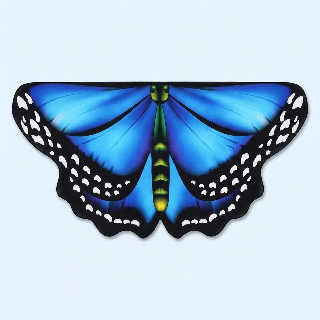 Bright blue butterfly wing cape with black spotted edges and a green body, laid flat on a pale blue background.