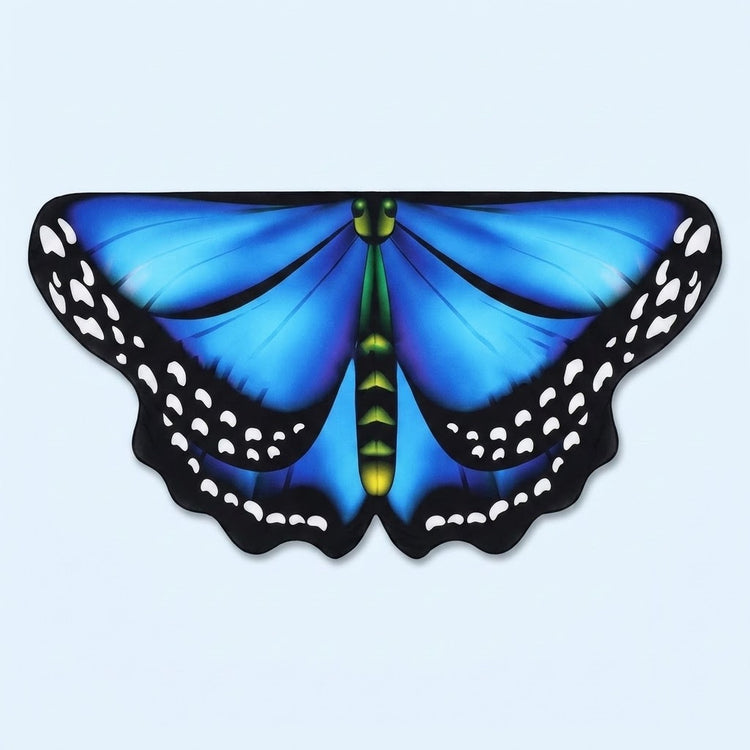 Bright blue butterfly wing cape with black spotted edges and a green body, laid flat on a pale blue background.
