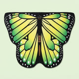 Green and yellow butterfly wing cape with black veined wings, white spotted borders, and a brown body, on a pale green background.