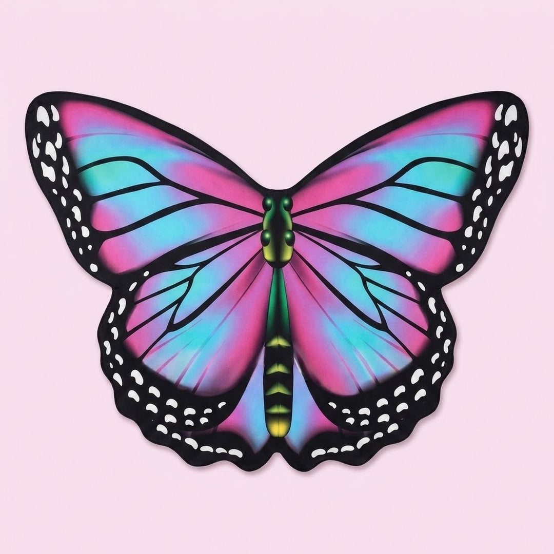 Pink and turquoise chiffon butterfly wing cape with black spotted borders and a green body, laid flat on a pink background.