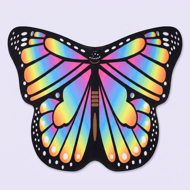 Rainbow butterfly wing cape with multicoloured veined wings, black spotted borders, and a brown body, on a pale lavender background.