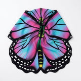 Pink and turquoise butterfly cape rests folded inward on a white background, showing black veins and white-spotted scalloped edges.