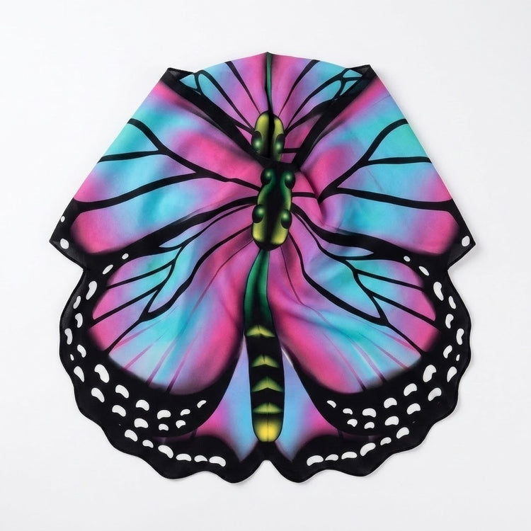 Pink and turquoise butterfly cape rests folded inward on a white background, showing black veins and white-spotted scalloped edges.