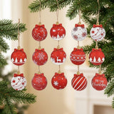 Red and white wooden Christmas ornaments with bow-shaped tops and festive patterns hang among evergreen branches against a softly blurred cream background.