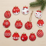 Twelve flat red and white Christmas ornaments with festive patterns lie on pale wood beside an evergreen branch and hanging twine.