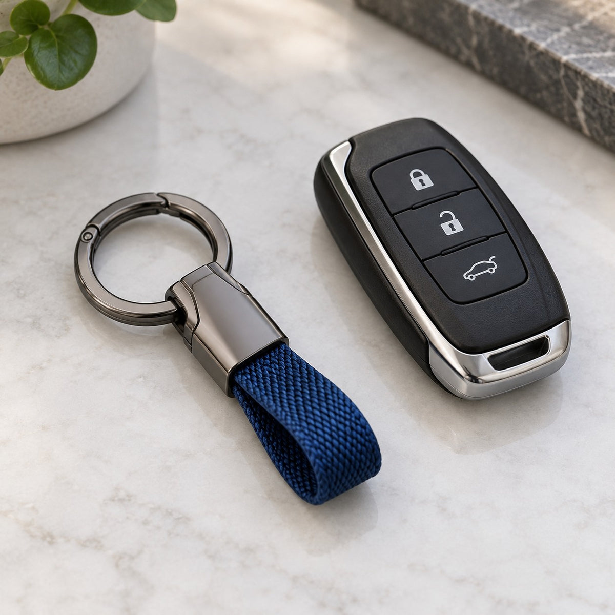 Blue Zinc Alloy Carabiner Keychain beside a car key fob on a tabletop to show its everyday scale.