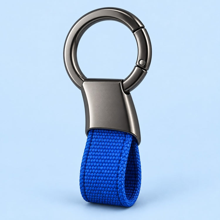 Blue Zinc Alloy Carabiner Keychain with a gunmetal circular ring on a soft blue studio background.