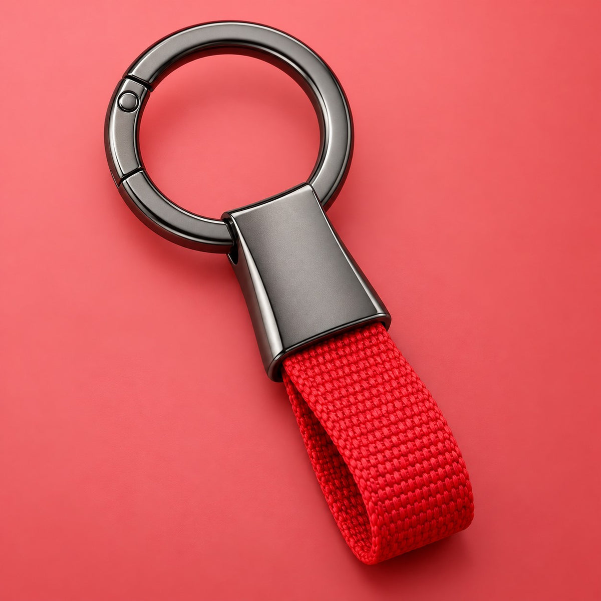 Red Zinc Alloy Carabiner Keychain with a gunmetal circular ring on a soft red studio background.