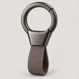 Grey Zinc Alloy Carabiner Keychain with a gunmetal circular ring on a light warm grey studio background.