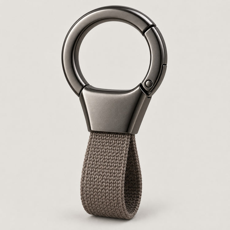 Grey Zinc Alloy Carabiner Keychain with a gunmetal circular ring on a light warm grey studio background.