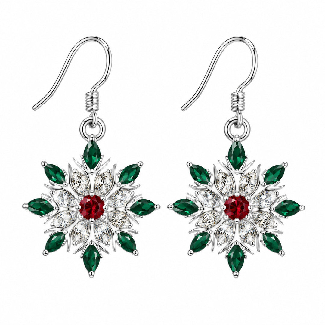 A matching pair of red and green accented snowflake stud earrings on a pure white background.
