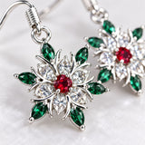 Macro detail reveals faceted clear stones, polished silver-tone metal, and colorful accents.