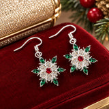 Snowflake starburst earrings add red and green sparkle to a festive evening dressing table.