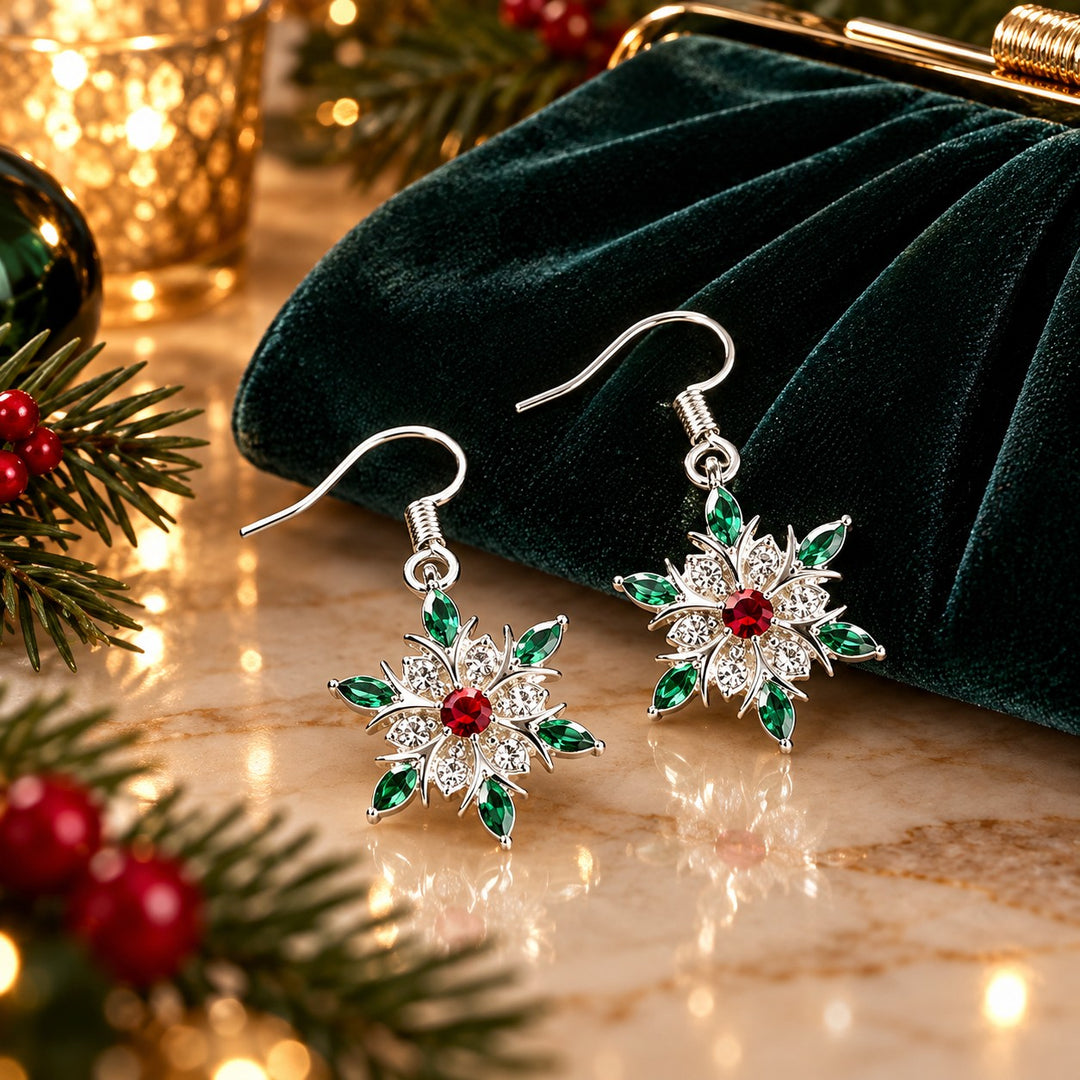 Snowflake starburst earrings sit beside an evening clutch and evergreen on a dressing table.