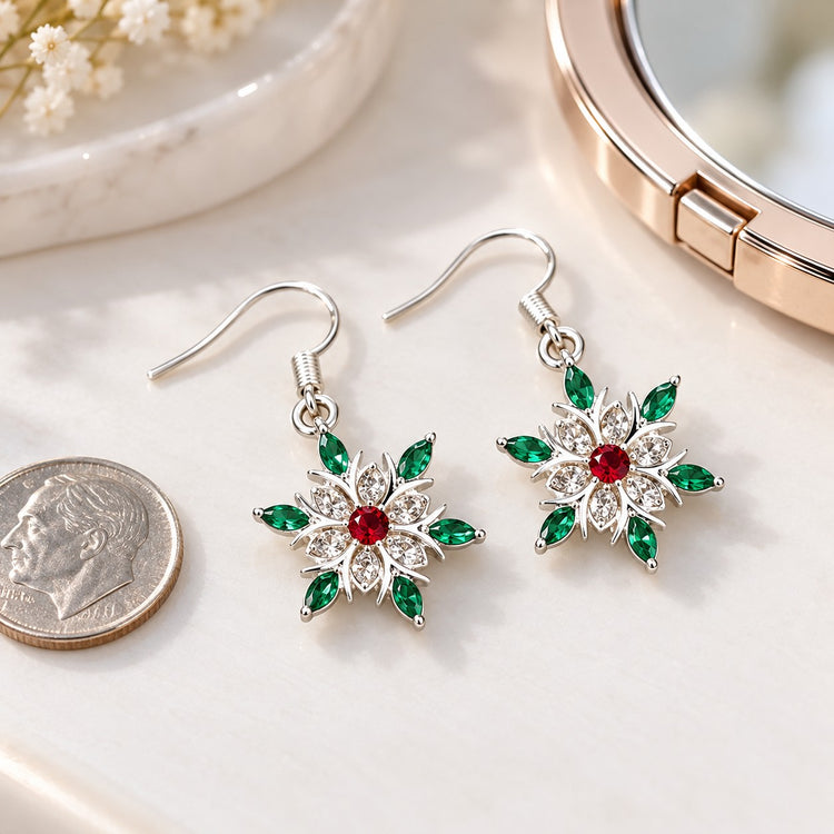 Petite snowflake stud earrings beside a coin show their compact scale on a dressing table.