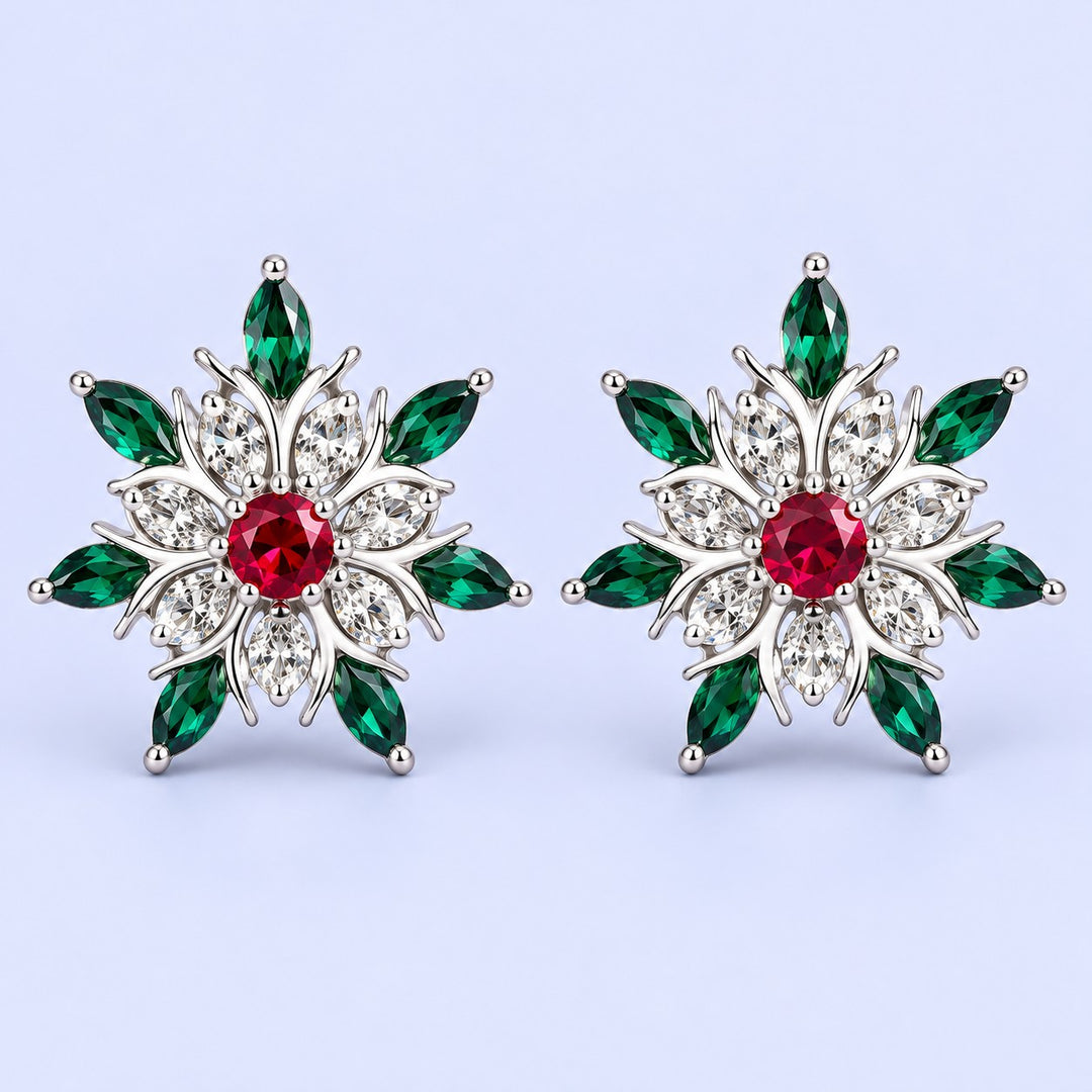 Silver snowflake stud earrings with red and green stones on a pale icy lavender backdrop.